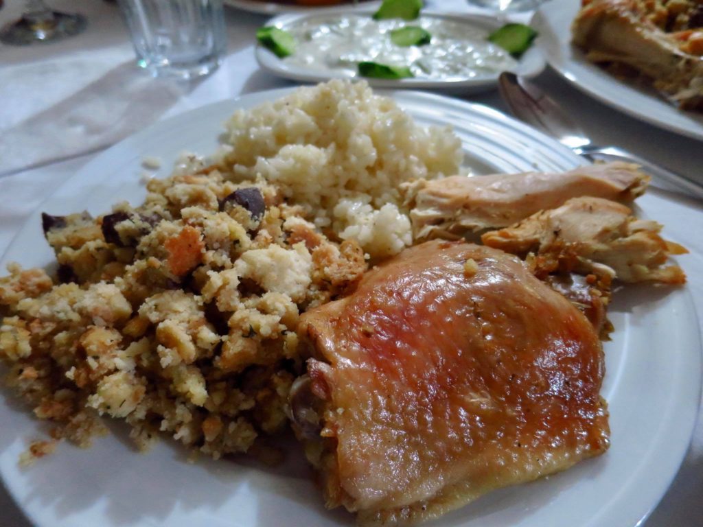 Thanksgiving style meal with chicken, stuffing, rice, and yogurt.